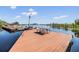 Spacious wooden dock features a picnic table and direct access to the serene lake, perfect for relaxation and recreation at 2511 Dolly Bay Dr # 304, Palm Harbor, FL 34684