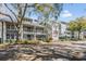 Condominium complex with multiple floors, white railings, and a well-maintained landscaped yard at 2511 Dolly Bay Dr # 304, Palm Harbor, FL 34684