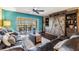 Living room features a modern sliding barn door entertainment center and access to a screened-in balcony at 2511 Dolly Bay Dr # 304, Palm Harbor, FL 34684