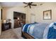 Bright main bedroom with fan, TV, and decorative fireplace at 2511 Dolly Bay Dr # 304, Palm Harbor, FL 34684