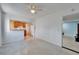 Open-concept living room with terrazzo floors connected to adjacent bedroom and kitchen at 2724 66Th S Ter, St Petersburg, FL 33712