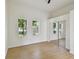 Bright bedroom featuring wood flooring, a mirrored sliding-door closet, and windows allowing natural light at 2725 W Beach St, Tampa, FL 33607