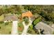 An aerial view of a well-maintained home featuring a circular driveway and professionally landscaped yard at 30 Stanton Cir, Oldsmar, FL 34677