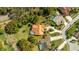 Aerial view of a private residence with a terracotta roof, screened-in pool, and verdant landscaping at 30 Stanton Cir, Oldsmar, FL 34677