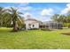 Lush backyard with a well-maintained lawn and screened lanai, offering a serene outdoor living space at 30 Stanton Cir, Oldsmar, FL 34677