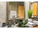 Bathroom featuring granite countertops, a stylish green glass bowl sink, and decorative plants at 30 Stanton Cir, Oldsmar, FL 34677