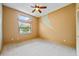 Spacious bedroom with a large window and neutral colored walls and carpet at 30 Stanton Cir, Oldsmar, FL 34677