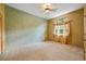 Bright bedroom with large window, neutral carpet, textured wall, and curtains at 30 Stanton Cir, Oldsmar, FL 34677