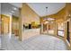 Bright dining room with tile floor, chandelier, and view to the kitchen and outdoor pool at 30 Stanton Cir, Oldsmar, FL 34677