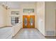 Bright foyer featuring tile flooring, high ceilings, decorative light fixtures, and a stylish front door at 30 Stanton Cir, Oldsmar, FL 34677