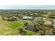 Aerial view of the expansive Golf Course, putting green, and nearby pond at 30 Stanton Cir, Oldsmar, FL 34677