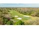 An aerial view captures the lush green fairway and meticulously maintained sand traps of the golf course at 30 Stanton Cir, Oldsmar, FL 34677