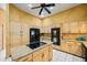 Spacious kitchen boasts granite counters, center island with cooktop, stainless steel appliances, and custom cabinetry at 30 Stanton Cir, Oldsmar, FL 34677