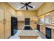 Spacious kitchen features granite counters, center island with cooktop, stainless steel appliances, and custom cabinetry at 30 Stanton Cir, Oldsmar, FL 34677