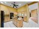 Open kitchen features granite counters, stainless steel appliances, custom cabinets, and access to the living room at 30 Stanton Cir, Oldsmar, FL 34677
