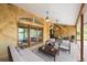 Cozy outdoor lanai with comfortable seating, pendant lighting, and views of the refreshing pool area at 30 Stanton Cir, Oldsmar, FL 34677