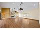 Bright living room features wood floors, fireplace, and vaulted ceilings with fans and recessed lighting at 30 Stanton Cir, Oldsmar, FL 34677