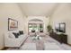 Staged living room boasts stylish furniture, decor, and ample natural light from a glass sliding door at 30 Stanton Cir, Oldsmar, FL 34677