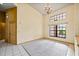 Bright living room features neutral carpet, large windows and a decorative chandelier at 30 Stanton Cir, Oldsmar, FL 34677