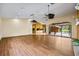 Bright living room features wood floors, vaulted ceilings with fans, and sliding glass doors to lanai and pool at 30 Stanton Cir, Oldsmar, FL 34677