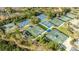 Aerial view of the Tennis Courts with well-maintained green courts and blue canopies at 30 Stanton Cir, Oldsmar, FL 34677