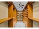 A spacious walk-in closet features custom shelving, drawers, and ample storage space at 30 Stanton Cir, Oldsmar, FL 34677