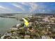 Aerial view of a waterfront condo offering a glimpse of city living amid lush trees at 30 Turner St # 203, Clearwater, FL 33756