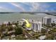 An aerial view shows a waterfront building with a pool, bay views, and city views at 30 Turner St # 203, Clearwater, FL 33756