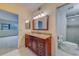 Bright bathroom featuring a granite-topped vanity with a framed mirror, complemented by marble floors at 30 Turner St # 203, Clearwater, FL 33756