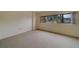 Bedroom with neutral walls and carpeting, and views of the outdoors at 30 Turner St # 203, Clearwater, FL 33756