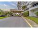 Covered entrance of the building, complemented by lush greenery and ample parking at 30 Turner St # 203, Clearwater, FL 33756