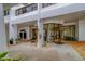 Exterior entrance to the building with well-maintained landscaping and convenient covered drop-off area at 30 Turner St # 203, Clearwater, FL 33756