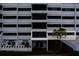 Multi-story condo building featuring balconies with dark window frames and palm trees at 30 Turner St # 203, Clearwater, FL 33756