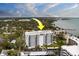 An exterior elevation of the condo building featuring private balconies and manicured landscaping at 30 Turner St # 203, Clearwater, FL 33756