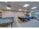 Well-lit game room featuring a pool table and ping pong setup, perfect for recreation and entertainment at 30 Turner St # 203, Clearwater, FL 33756