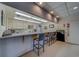 Community kitchen with bar seating, white cabinetry, and ample counter space at 30 Turner St # 203, Clearwater, FL 33756