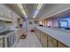 Well-lit communal kitchen with long counter and extensive cabinet storage at 30 Turner St # 203, Clearwater, FL 33756