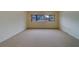 Living area with carpet and bright light from the window at 30 Turner St # 203, Clearwater, FL 33756