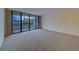 Relaxing living room featuring carpet flooring, neutral walls, and a large sliding glass door with balcony access at 30 Turner St # 203, Clearwater, FL 33756