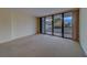 Inviting living room featuring carpet floors and sliding glass doors that lead to the balcony at 30 Turner St # 203, Clearwater, FL 33756