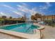 Inviting community pool area with lounge chairs, umbrellas, and palm trees under a blue sky at 30 Turner St # 203, Clearwater, FL 33756