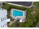 Aerial view of the community pool with plenty of lounge chairs, surrounded by well-maintained landscaping at 30 Turner St # 203, Clearwater, FL 33756