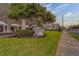 Street view showing building signage amidst manicured lawn and mature trees at 30 Turner St # 203, Clearwater, FL 33756