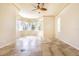 Spacious bedroom with tile floor, ceiling fan and bay windows with plantation shutters at 3015 Northfield Dr, Tarpon Springs, FL 34688