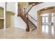 Elegant foyer with staircase featuring wood railing, and tile flooring at 3015 Northfield Dr, Tarpon Springs, FL 34688