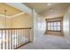 Upstairs landing with carpet and view of window with plantation shutters at 3015 Northfield Dr, Tarpon Springs, FL 34688