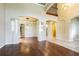 Open-concept living room with high ceilings, hardwood floors, and elegant columns defining the space at 3015 Northfield Dr, Tarpon Springs, FL 34688