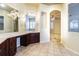 Main bathroom featuring a vanity with dark wood cabinets, a large mirror, and tile flooring at 3015 Northfield Dr, Tarpon Springs, FL 34688