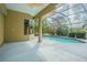 Inviting screened-in patio with view of a sparkling pool and lush landscaping for ultimate outdoor living at 3015 Northfield Dr, Tarpon Springs, FL 34688