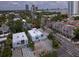 An aerial shot captures a bright, modern home in a leafy neighborhood, complemented by a skyline and bay views at 3101 W El Prado Blvd # B, Tampa, FL 33629
